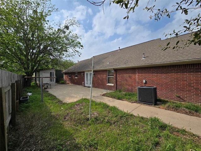 177 E Davilla St, Bartlett, TX 76511 - back of house with central air condition unit, fence, a patio area, an outdoor structure, and a shed