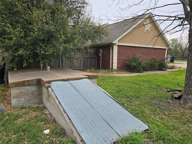 177 E Davilla St, Bartlett, TX 76511 - exterior space with brick siding, a shingled roof, fence, a downspout, and gutters