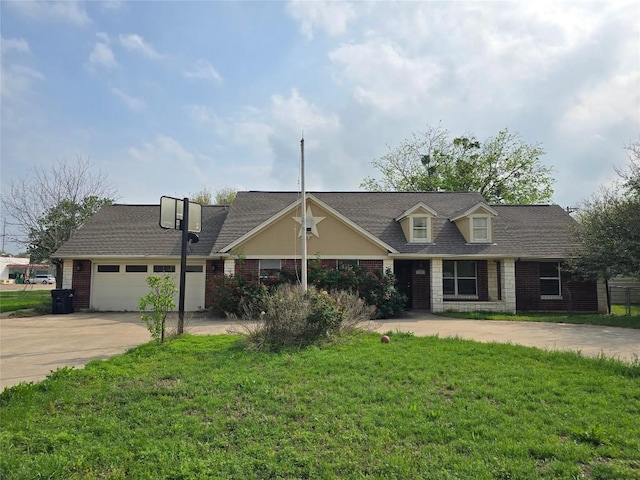 177 E Davilla St, Bartlett, TX 76511 - view of front of home featuring a front lawn, driveway, brick siding, a garage, and a shingled roof