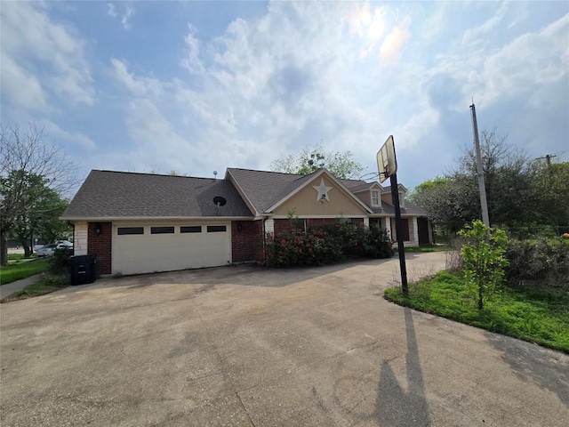 177 E Davilla St, Bartlett, TX 76511 - view of property exterior featuring concrete driveway, brick siding, roof with shingles, and a garage