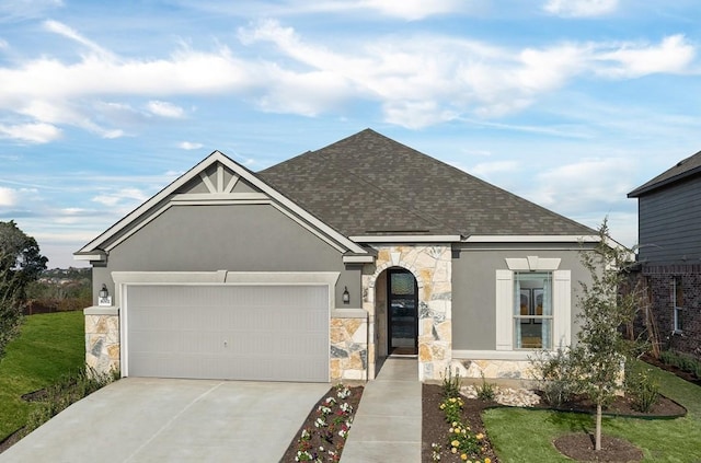 view of front of property with a garage and a front lawn