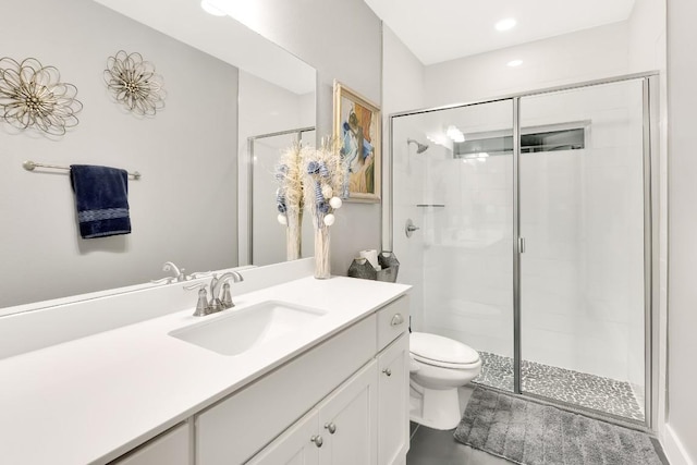 bathroom featuring vanity, walk in shower, and toilet