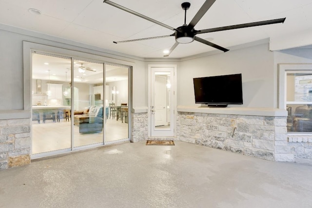 unfurnished living room with concrete flooring and ceiling fan