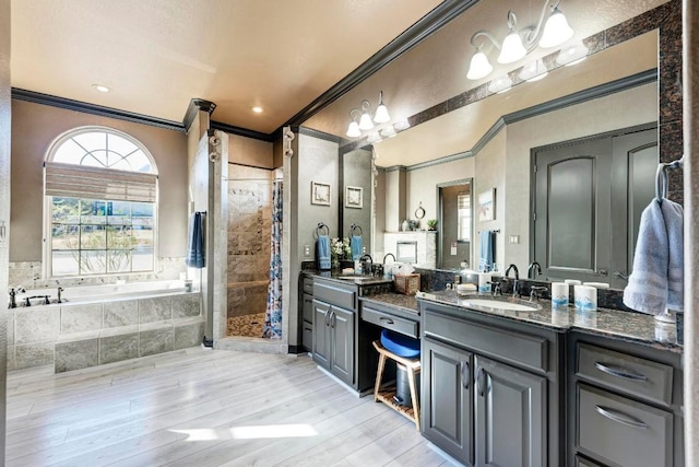 bathroom with vanity, crown molding, shower with separate bathtub, and hardwood / wood-style flooring