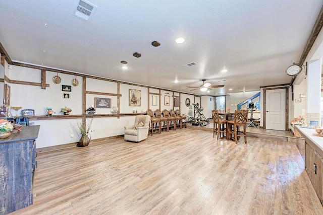 interior space with ceiling fan and light hardwood / wood-style floors