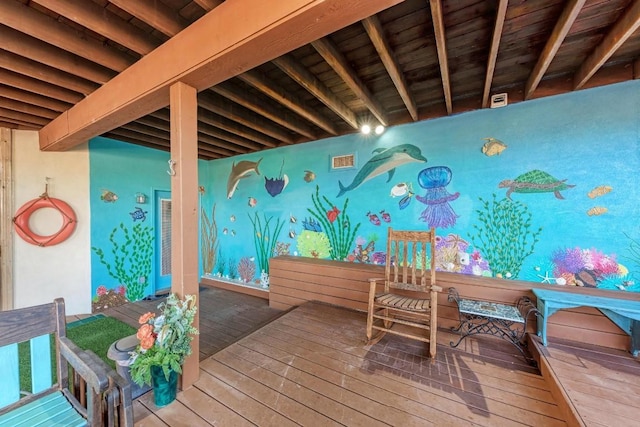 interior space with beamed ceiling and hardwood / wood-style floors