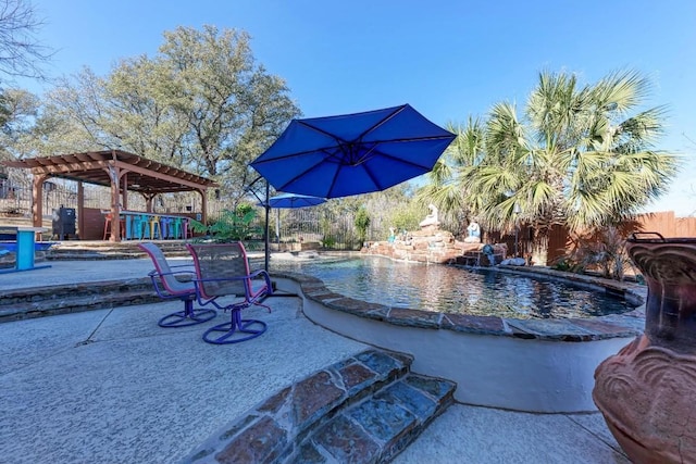 view of swimming pool with pool water feature and a patio area