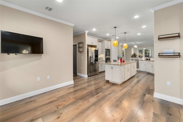 kitchen featuring stainless steel appliances, a center island, pendant lighting, and white cabinets