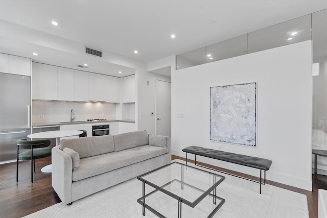 living room featuring light hardwood / wood-style floors and sink