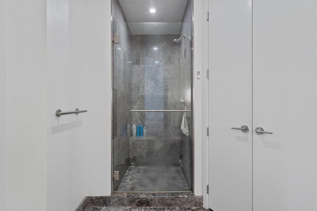 bathroom featuring a shower with shower door