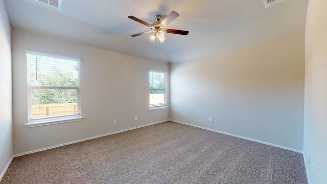 unfurnished room with ceiling fan and carpet