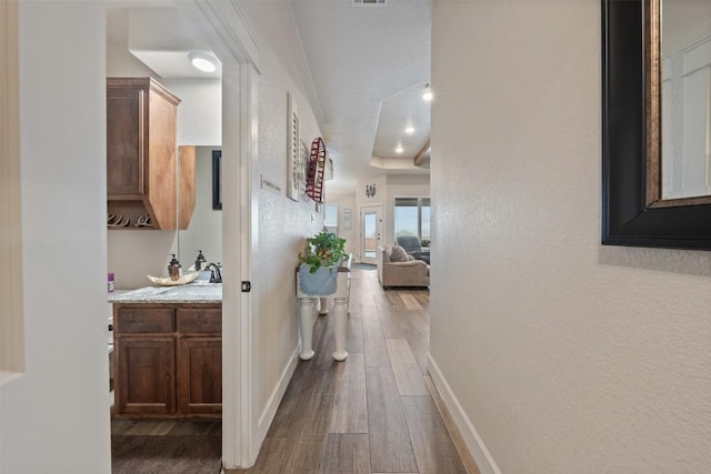 corridor with hardwood / wood-style floors