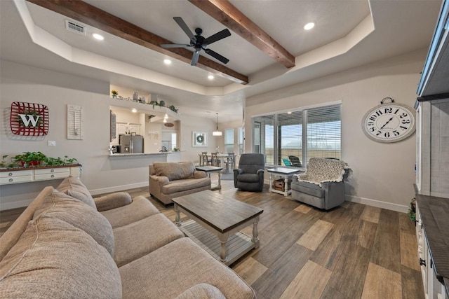 living room featuring beamed ceiling, hardwood / wood-style floors, and ceiling fan