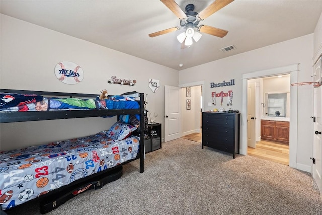 carpeted bedroom featuring ensuite bathroom and ceiling fan