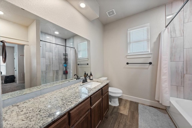 full bathroom featuring vanity, wood-type flooring, toilet, and shower / tub combo with curtain