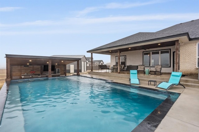 view of pool with pool water feature and a patio