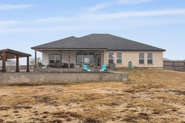 back of property featuring a yard, a patio, and ceiling fan