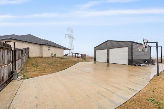 view of patio with an outbuilding and a garage