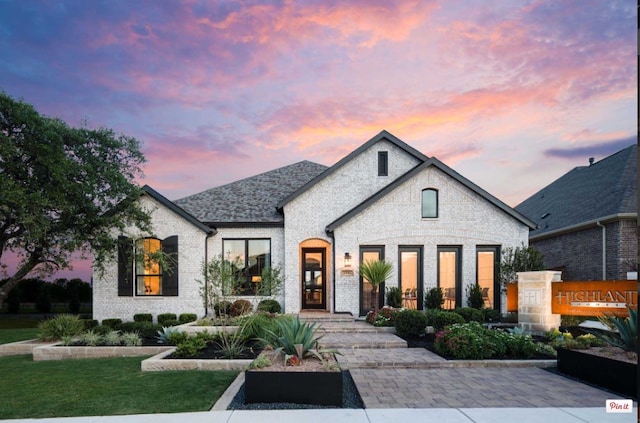 french country style house with a lawn