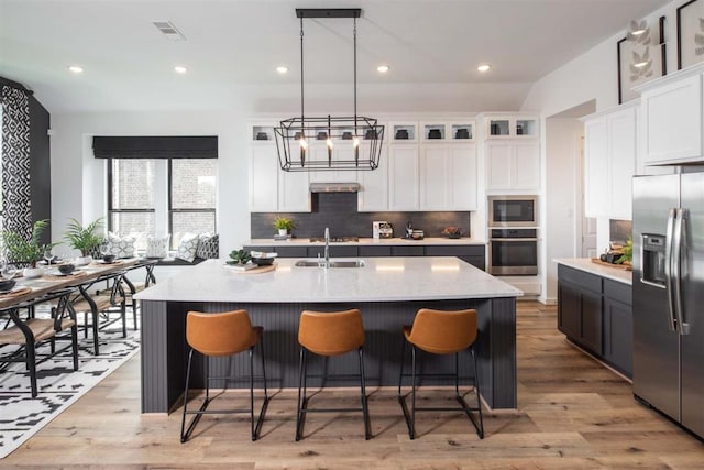 2516 Carretera Dr, Leander, TX 78641 - kitchen with decorative backsplash, white cabinets, appliances with stainless steel finishes, and a sink