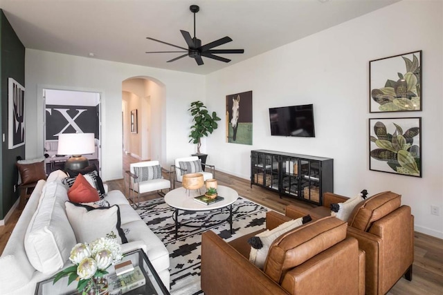 2516 Carretera Dr, Leander, TX 78641 - living area with ceiling fan, wood finished floors, baseboards, and arched walkways