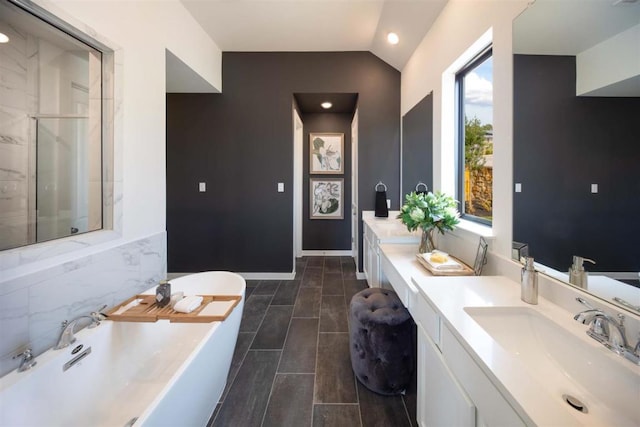 2516 Carretera Dr, Leander, TX 78641 - full bath with vanity, vaulted ceiling, a stall shower, tile patterned flooring, and a freestanding bath