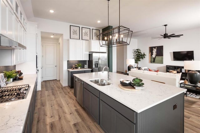 2516 Carretera Dr, Leander, TX 78641 - kitchen with appliances with stainless steel finishes, light wood-style flooring, white cabinets, and recessed lighting