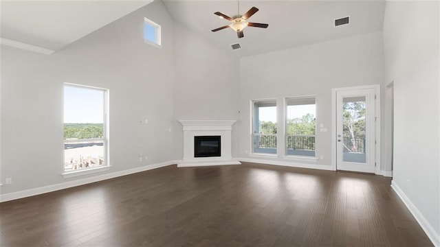 unfurnished living room with high vaulted ceiling, dark hardwood / wood-style floors, and ceiling fan