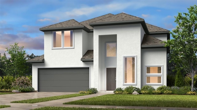 view of front of property featuring a garage and a lawn