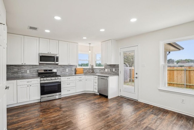 kitchen featuring stainless steel appliances and white cabinets