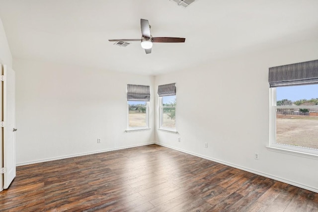 empty room with dark hardwood / wood-style floors and ceiling fan