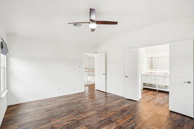 unfurnished bedroom featuring lofted ceiling, dark wood-type flooring, and ceiling fan