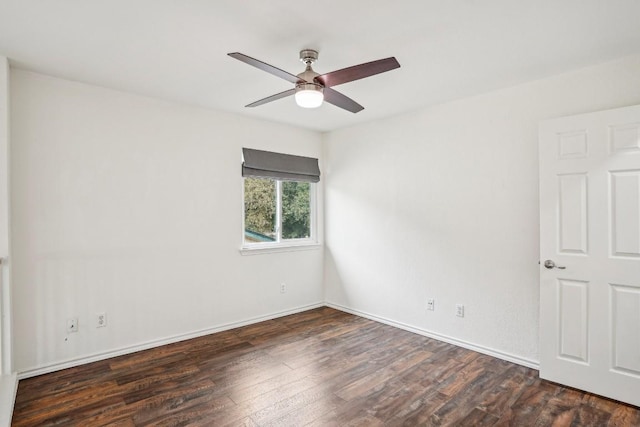 spare room with dark wood-type flooring and ceiling fan