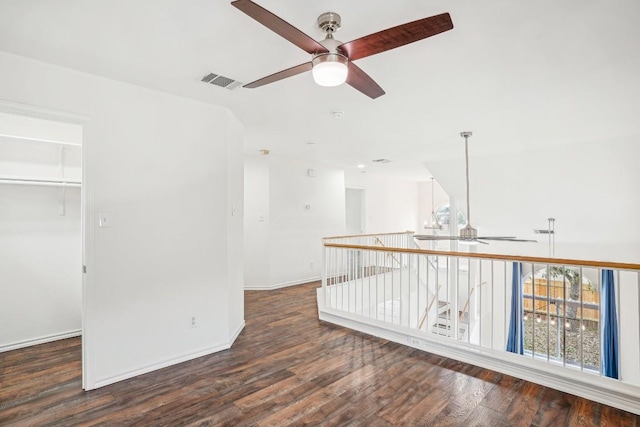 spare room featuring dark wood-type flooring and ceiling fan