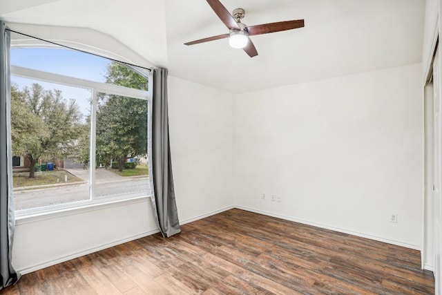 spare room featuring lofted ceiling, dark hardwood / wood-style floors, and ceiling fan