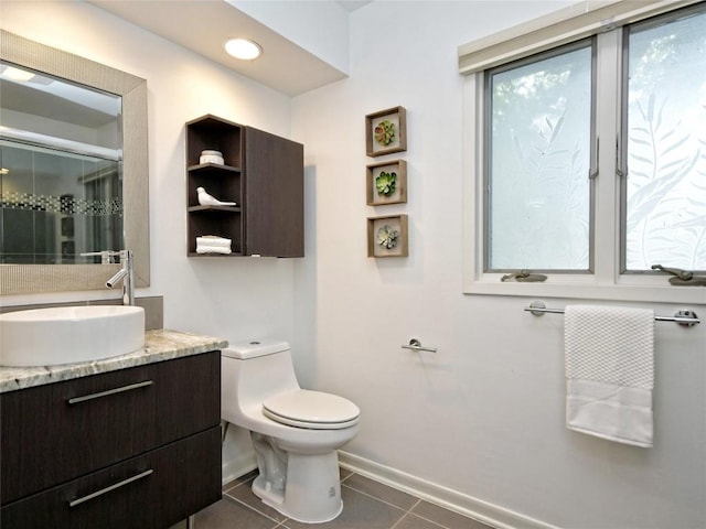 bathroom featuring walk in shower, tile patterned floors, toilet, and vanity