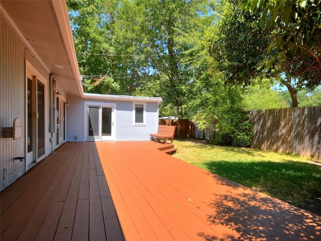 wooden terrace featuring a lawn