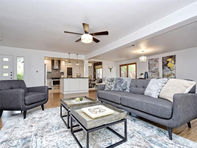 living room with light hardwood / wood-style floors and ceiling fan