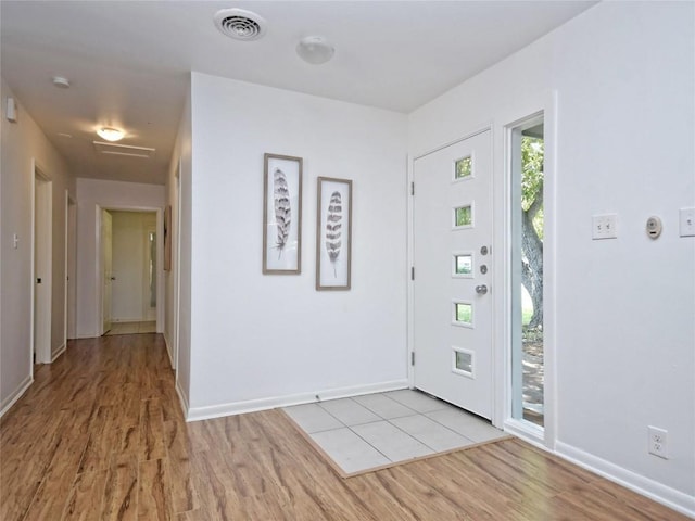 foyer entrance with light hardwood / wood-style flooring