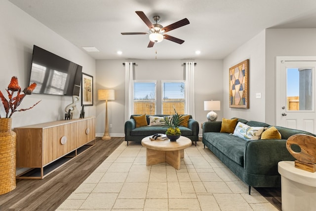 living room with ceiling fan and light hardwood / wood-style flooring