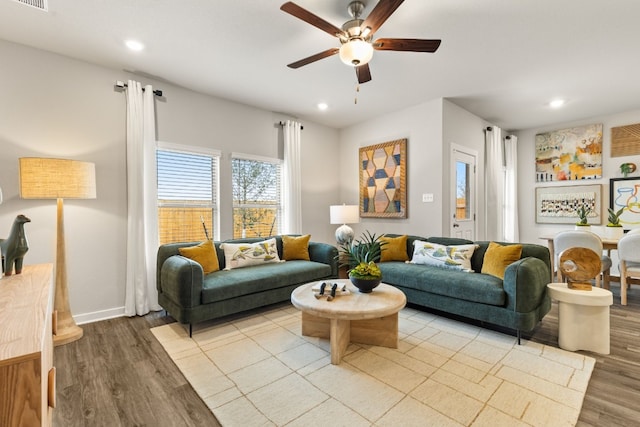 living room with ceiling fan and light hardwood / wood-style floors