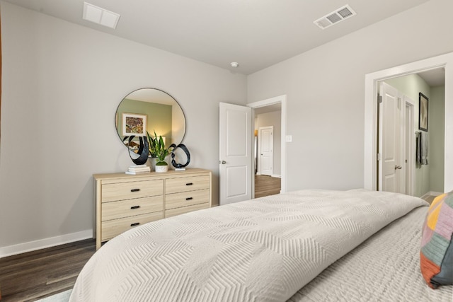 bedroom with dark hardwood / wood-style floors