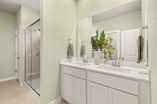 bathroom with tile patterned flooring, vanity, and a shower with shower door