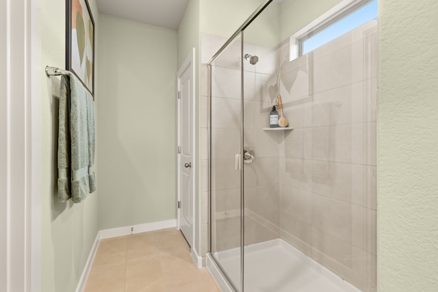 bathroom with tile patterned floors and walk in shower