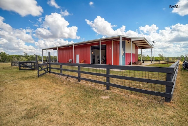 view of side of home with an outbuilding and a rural view