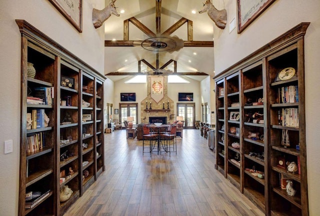 0000 Gotier Trace Rd, Smithville, TX 78957 - wine room with ceiling fan, a stone fireplace, high vaulted ceiling, wood finished floors, and beamed ceiling