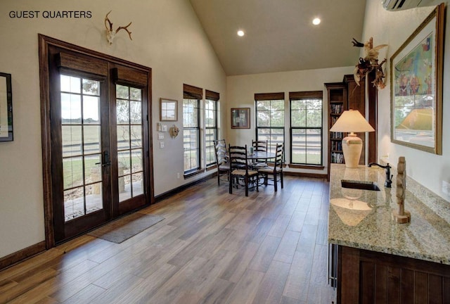 0000 Gotier Trace Rd, Smithville, TX 78957 - dining space featuring french doors, wood finished floors, recessed lighting, high vaulted ceiling, and baseboards