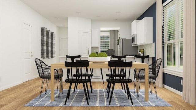 dining space with light hardwood / wood-style flooring