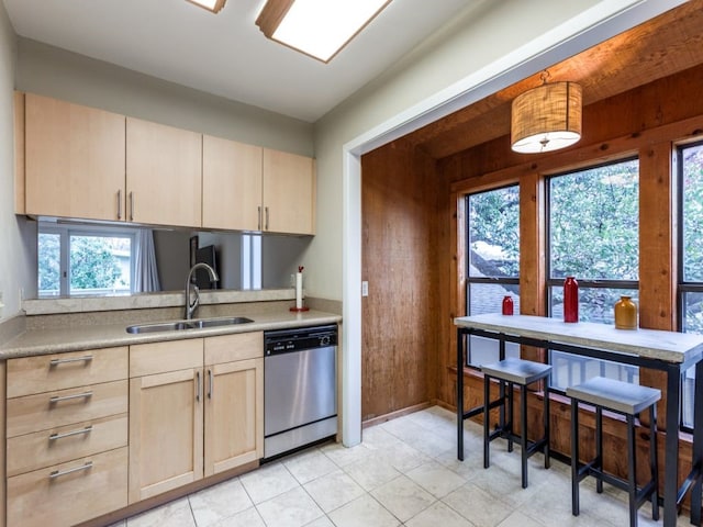 kitchen with pendant lighting, sink, dishwasher, plenty of natural light, and light brown cabinetry