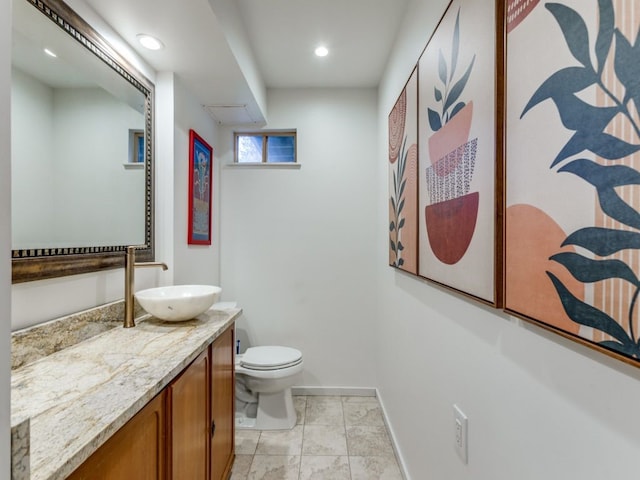 bathroom with tile patterned flooring, vanity, and toilet